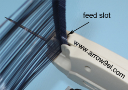 Load the the connecting bar to the feed slot of the tag gun 